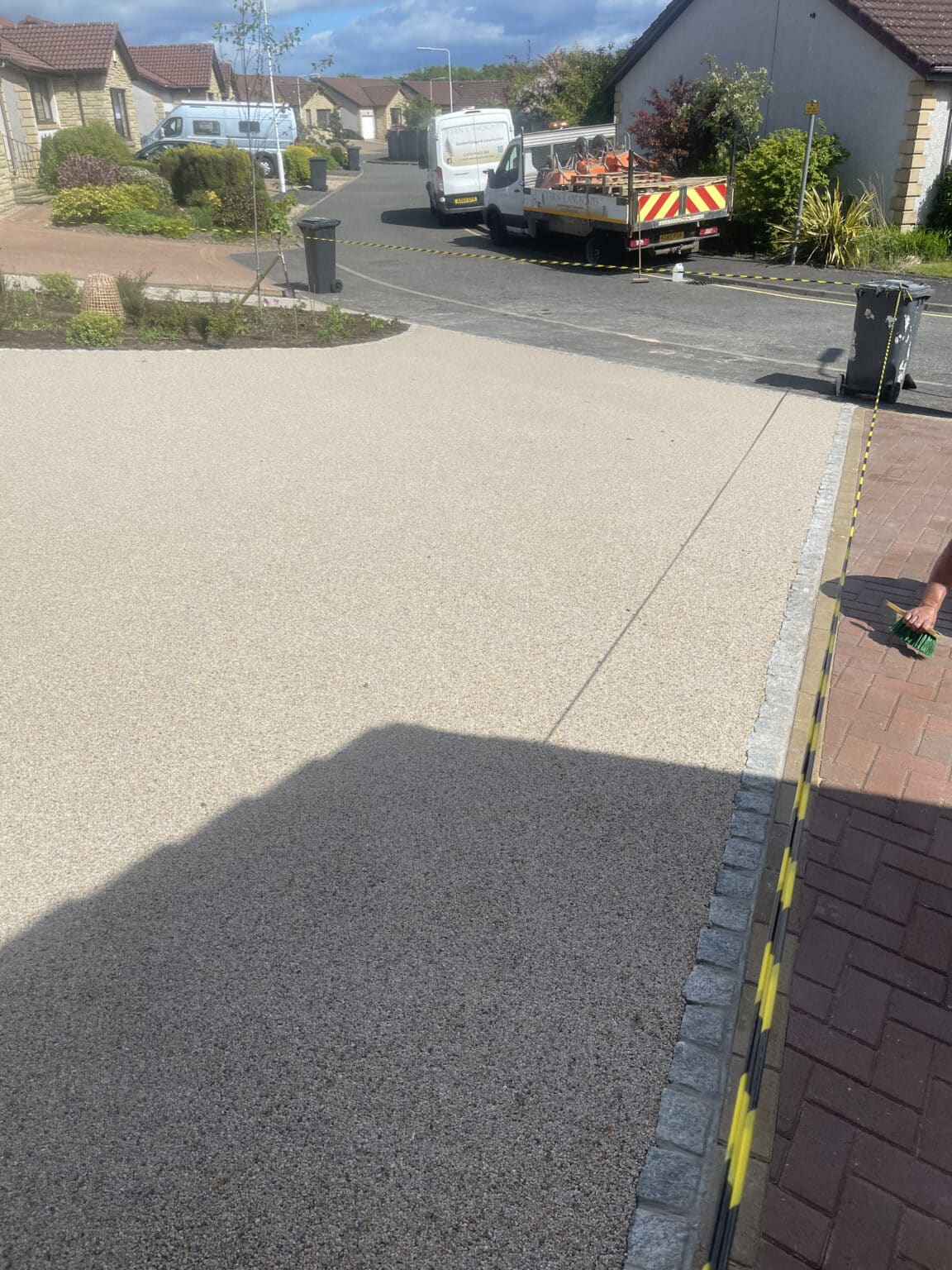 Driveway completed with resin and parked cars and van
