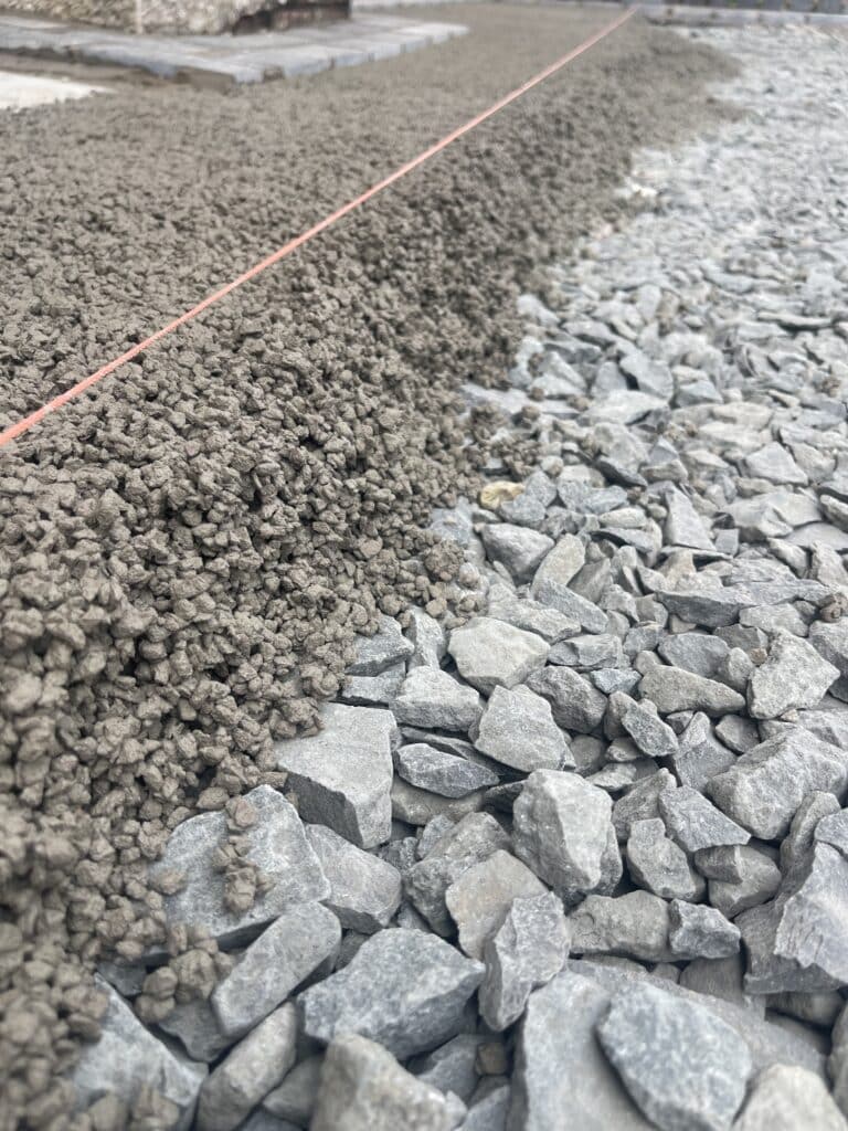 Gravel and rocks with plumb line for edging